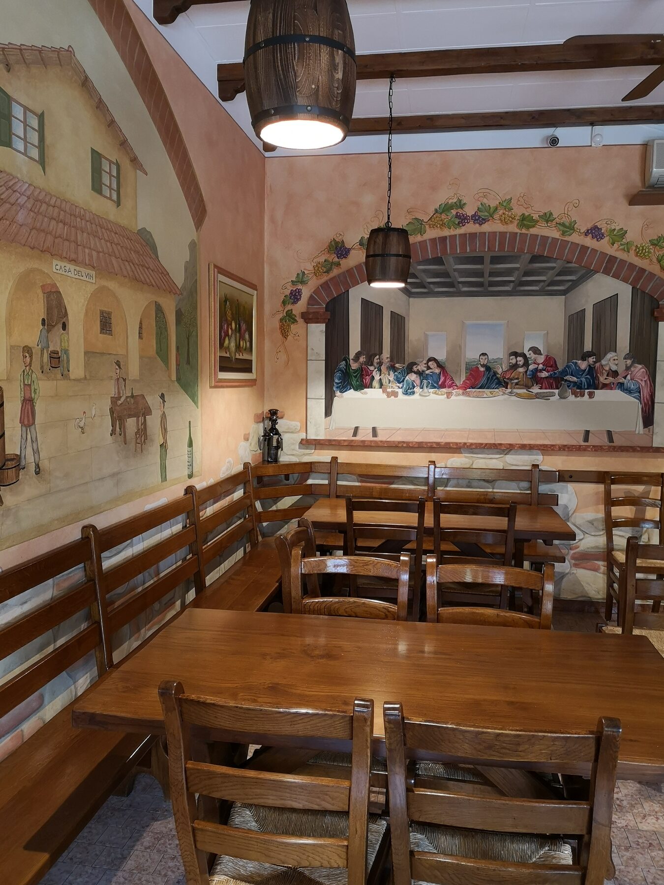 La sala dell'osteria con tavoli e sedie in legno